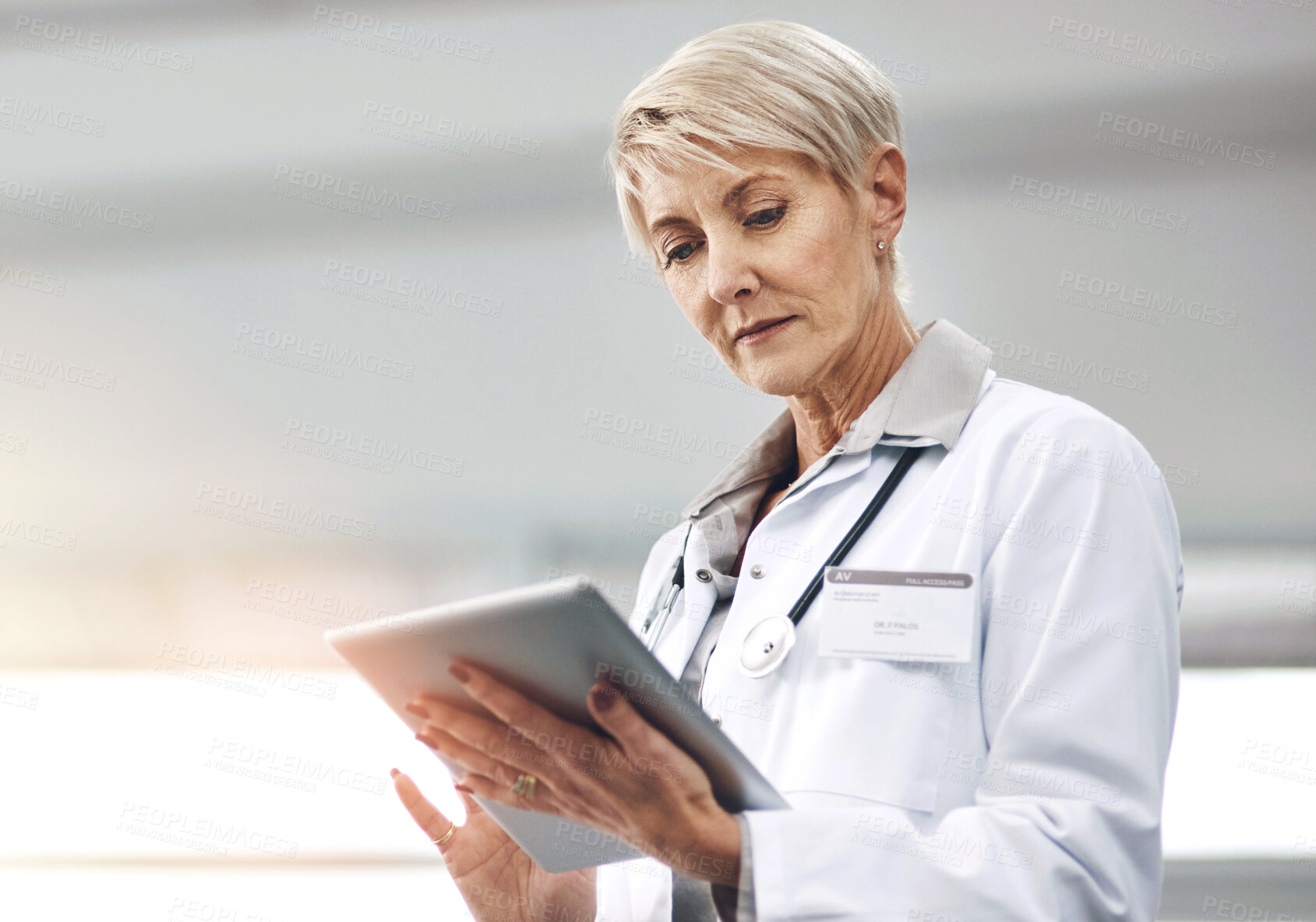 Buy stock photo Doctor, medical and tablet with mature woman in hospital for analysis, cardiology or reading research. Healthcare, stethoscope and technology with confident medicine professional in clinic for info