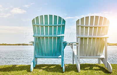 Buy stock photo Blue sky, sunshine and chair on grass at lake for environment, scenery and relax in summer. Clouds, nature and bench on outdoor field by water for sitting view, holiday and vacation in California