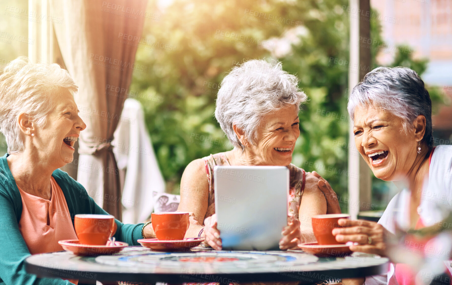 Buy stock photo Cafe, laughing and tablet with elderly women at table outdoor together for bonding or social media. Funny, happy or smile with senior friends at sidewalk coffee shop, tech for app or memories