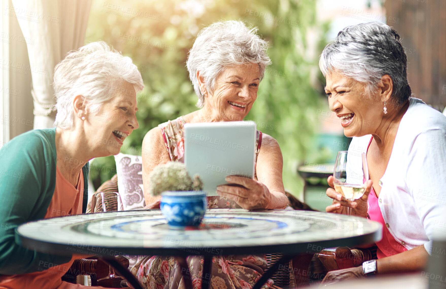 Buy stock photo Senior woman, cafe and friends with tablet for memory, bonding and laughing while drinking wine. Elderly people, restaurant and relax with technology for internet, joke and social media with alcohol