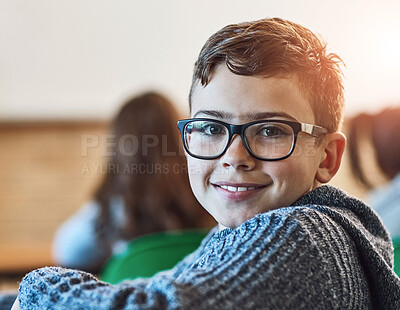 Buy stock photo Boy, class and portrait of face with glasses for education, learning and development in junior school. Male learner, smile and knowledge in classroom for subject, growth and happiness for information