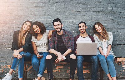 Buy stock photo Friends, portrait and happy outdoor with laptop for social network, support or communication by brick wall. Group of people, student and community with technology for diversity, relax or relationship