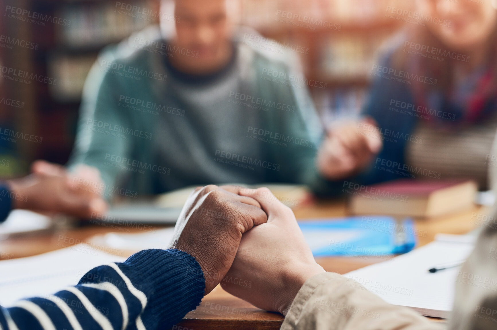 Buy stock photo Students, people or holding hands in prayer in library for blessings, grace or guidance in college. Closeup, friends and hope with spirituality for thanks, school or teamwork in study group for exams