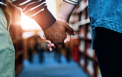 Buy stock photo Holding hands, love and interracial friends with partnership, connection and support for education. Library, students and people touching for care and solidarity for study with university exam.