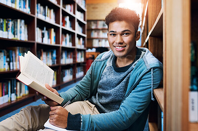 Buy stock photo Student, man and portrait with writing in library for studying, scholarship and reading a book for exam information. Education, person or happy with notebook for research notes and knowledge on floor