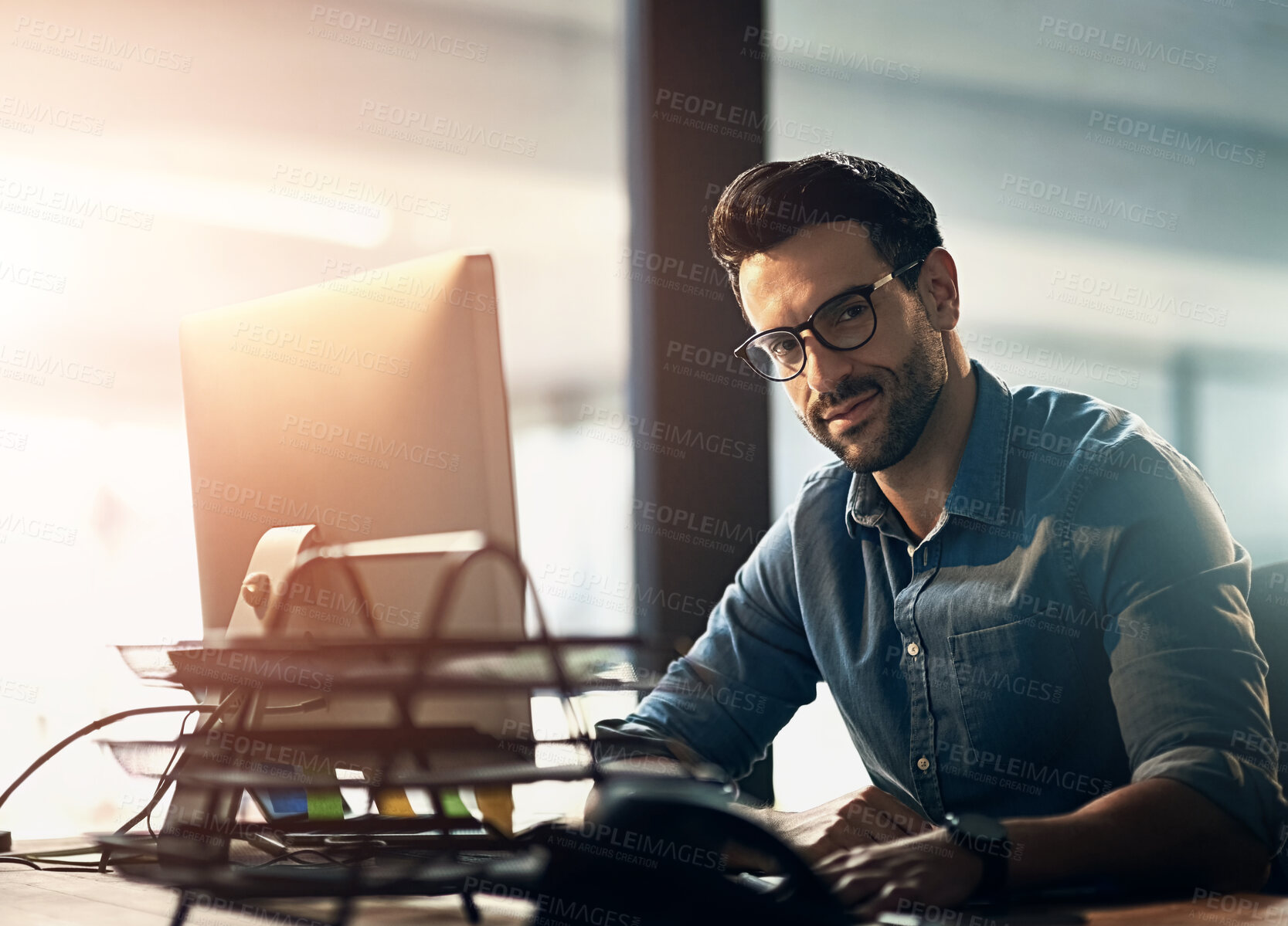 Buy stock photo Working man, computer and portrait in office for business, happy for overtime at corporate company. Male person, desktop and tech with glasses for vision with design, planning for website development