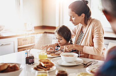 Buy stock photo Mother, child and toast for breakfast with help, support and family in kitchen at home. Woman, daughter and cutting bread at table for food, nutrition and healthy meal in morning with parents