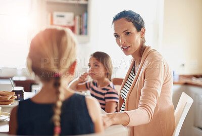 Buy stock photo Woman, children and talking at breakfast in kitchen for bonding, love and care with healthy nutrition in morning. Mother, girl and happy family with conversation, support and eating lunch at house