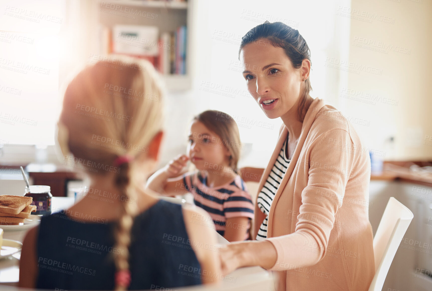 Buy stock photo Woman, children and talking at breakfast in kitchen for bonding, love and care with healthy nutrition in morning. Mother, girl and happy family with conversation, support and eating lunch at house