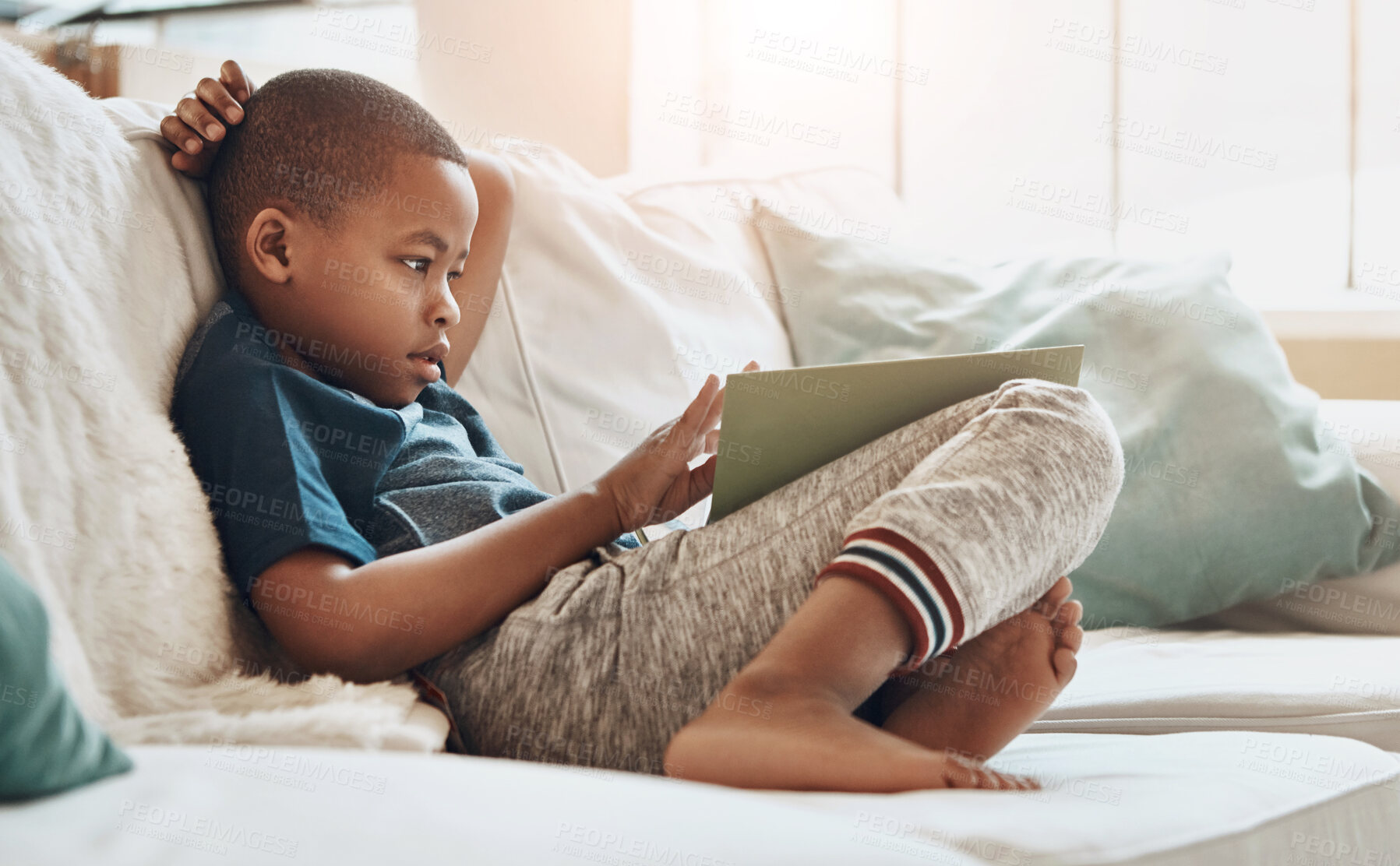 Buy stock photo Boy, reading and book in lounge for education, development and growth for story, knowledge or learning. Young child, relax and comfort for entertainment, school or hobby as preteen in home on weekend