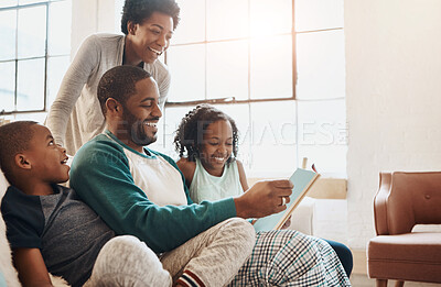 Buy stock photo Reading, book and children with parents on sofa for bonding together on fathers day at home. Happy, knowledge and black family relaxing in living room with story or novel for language development.