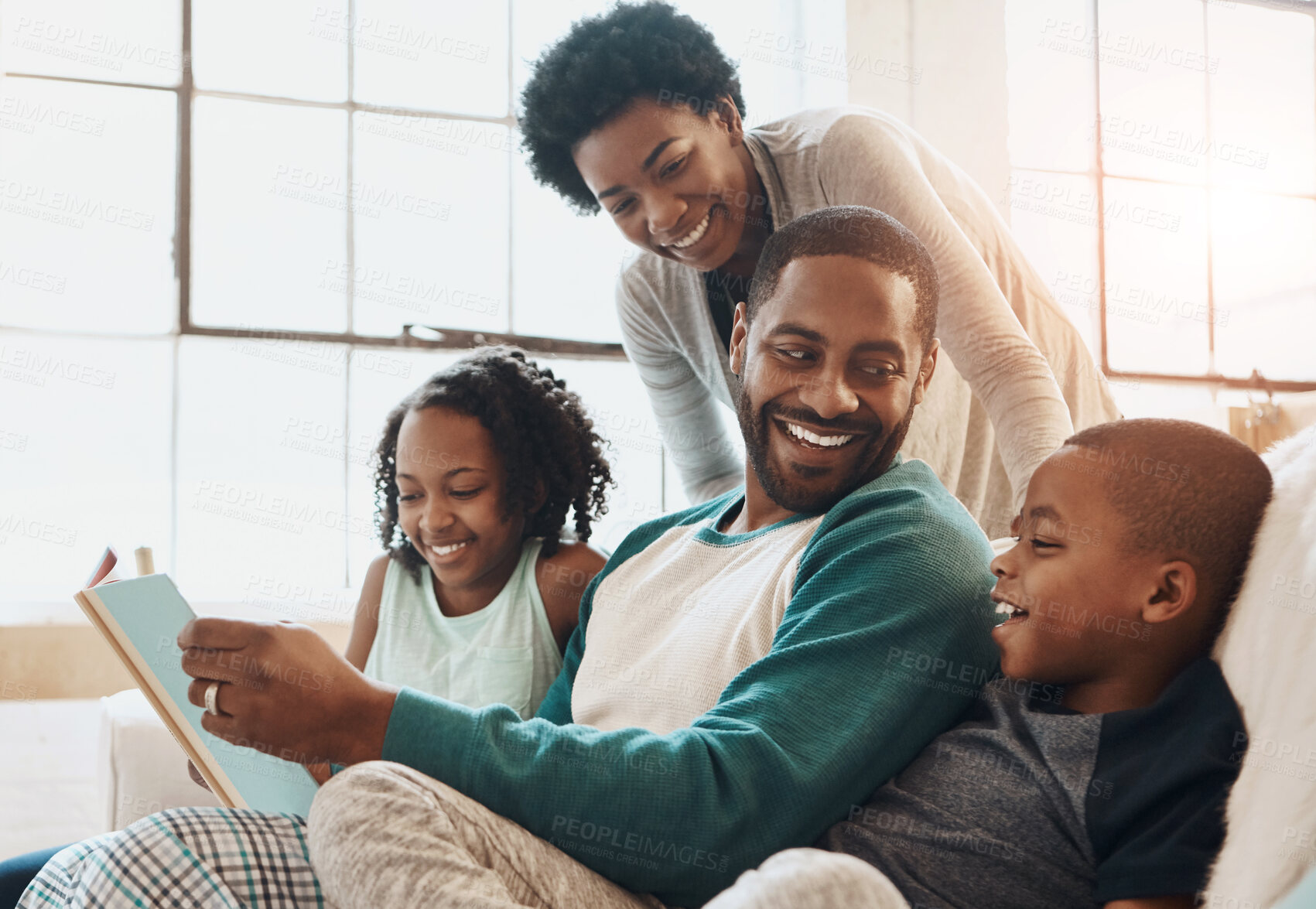 Buy stock photo Reading, happy and black family with book on sofa for bonding together on fathers day at home. Smile, knowledge and African parents relaxing with children in living room with fantasy story or novel.