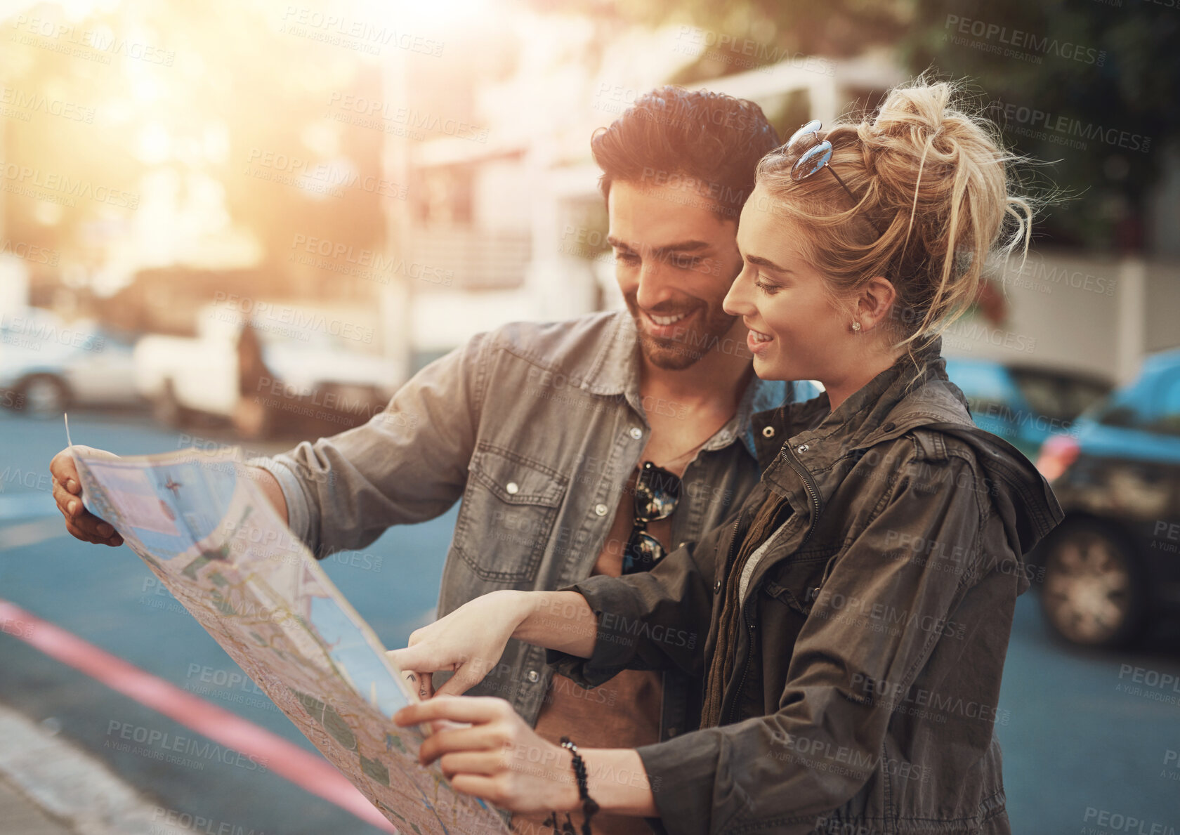 Buy stock photo Travel, man and woman in paper map, smile and location search on urban holiday adventure in road. Walk, guide and happy couple reading direction in city street for fun vacation in Europe together.