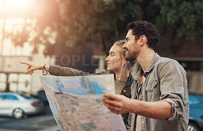 Buy stock photo Travel, map and couple pointing in city for adventure, holiday or directions in Budapest. Tourist, young woman and happy man with document for location, search destination or outdoor sightseeing