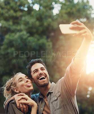 Buy stock photo Camping, selfie and happy couple hug in forest with fun, bonding and funny sunset memory in nature. Love, profile picture or people in park for travel influencer blog, content creation or photography