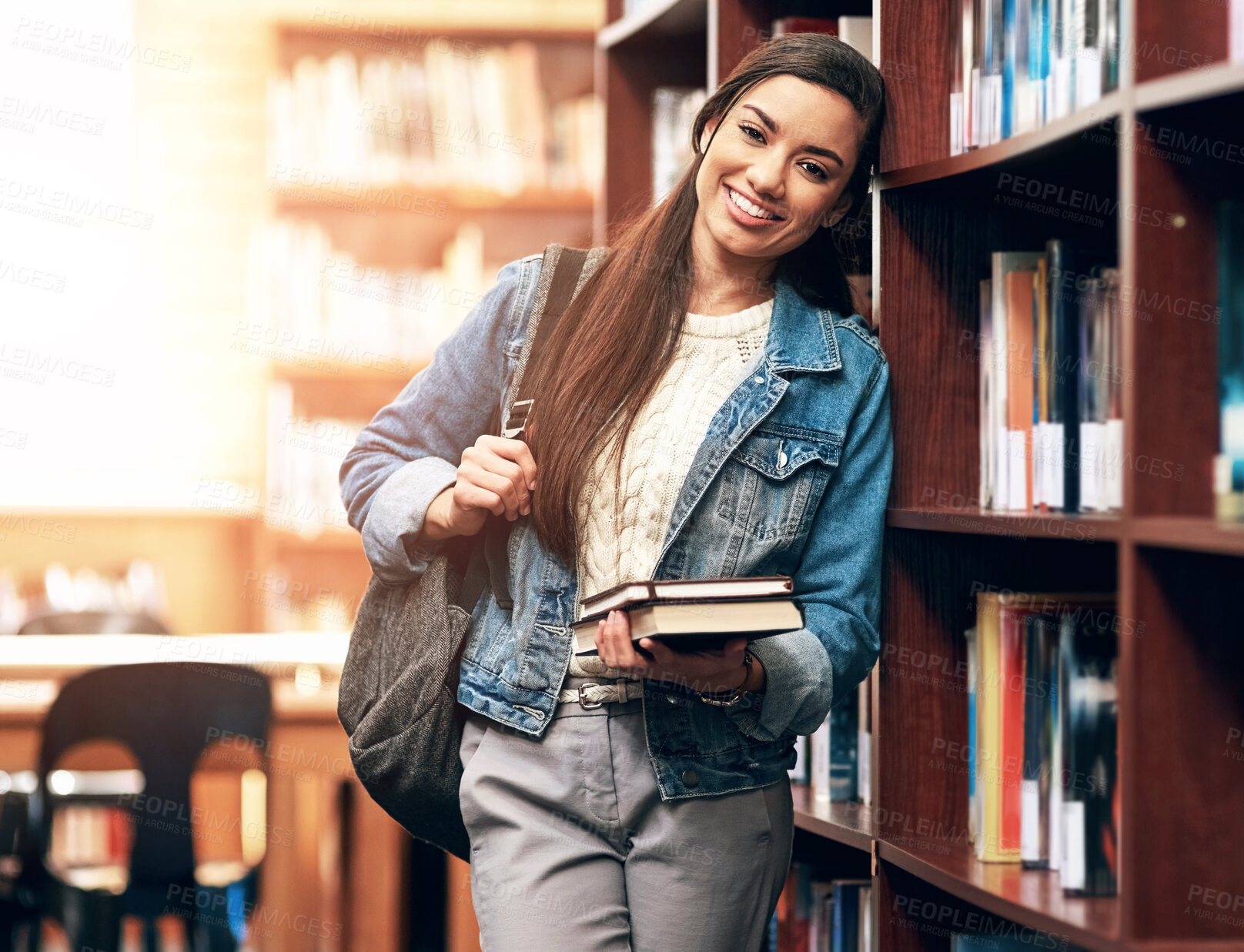 Buy stock photo Portrait, student and girl with books in library with smile for education, development and study at college. Proud, school and happy woman for research, course knowledge and scholarship at university