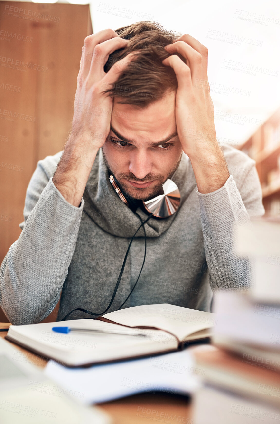 Buy stock photo Man, student and stress in library with notebook, education and knowledge study for learning university male person. Burnout, anxiety and mental health for research assignment, frustrated and project