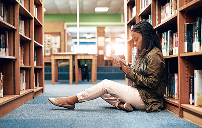 Buy stock photo Woman, tablet and reading in library for education, research and studying in university. Female student, technology and learning by bookshelf for relaxation, social media or ebook for information