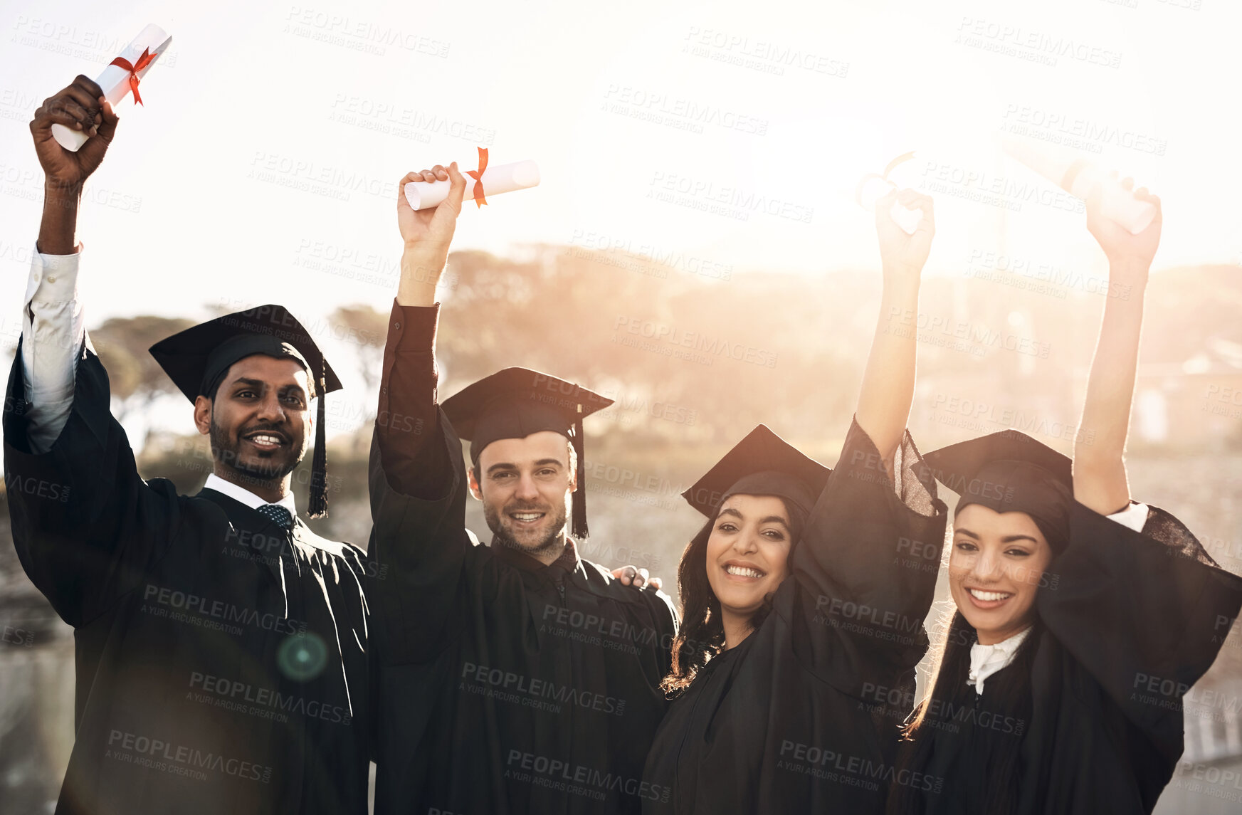 Buy stock photo Students, graduation and happy with hands up on campus for celebration and success. People, college and university classmate or friends on smile on portrait for qualification, certificate and excited
