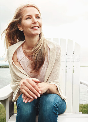 Buy stock photo Mature woman, peace and wind outdoor for holiday, travel and mindfulness by lake with happiness. Female person, calm and breeze in nature for vacation, summer and wellness by pond with smile or hope