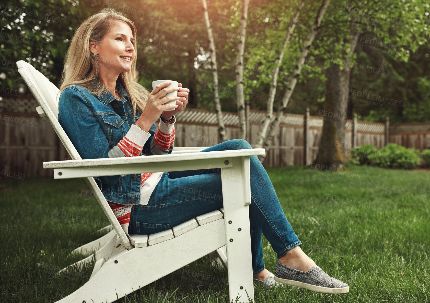 Buy stock photo Coffee, nature and woman relaxing in backyard for calm, peace and break on weekend evening. Smile, home and mature female person on outdoor chair drinking cappuccino, latte or espresso in garden.