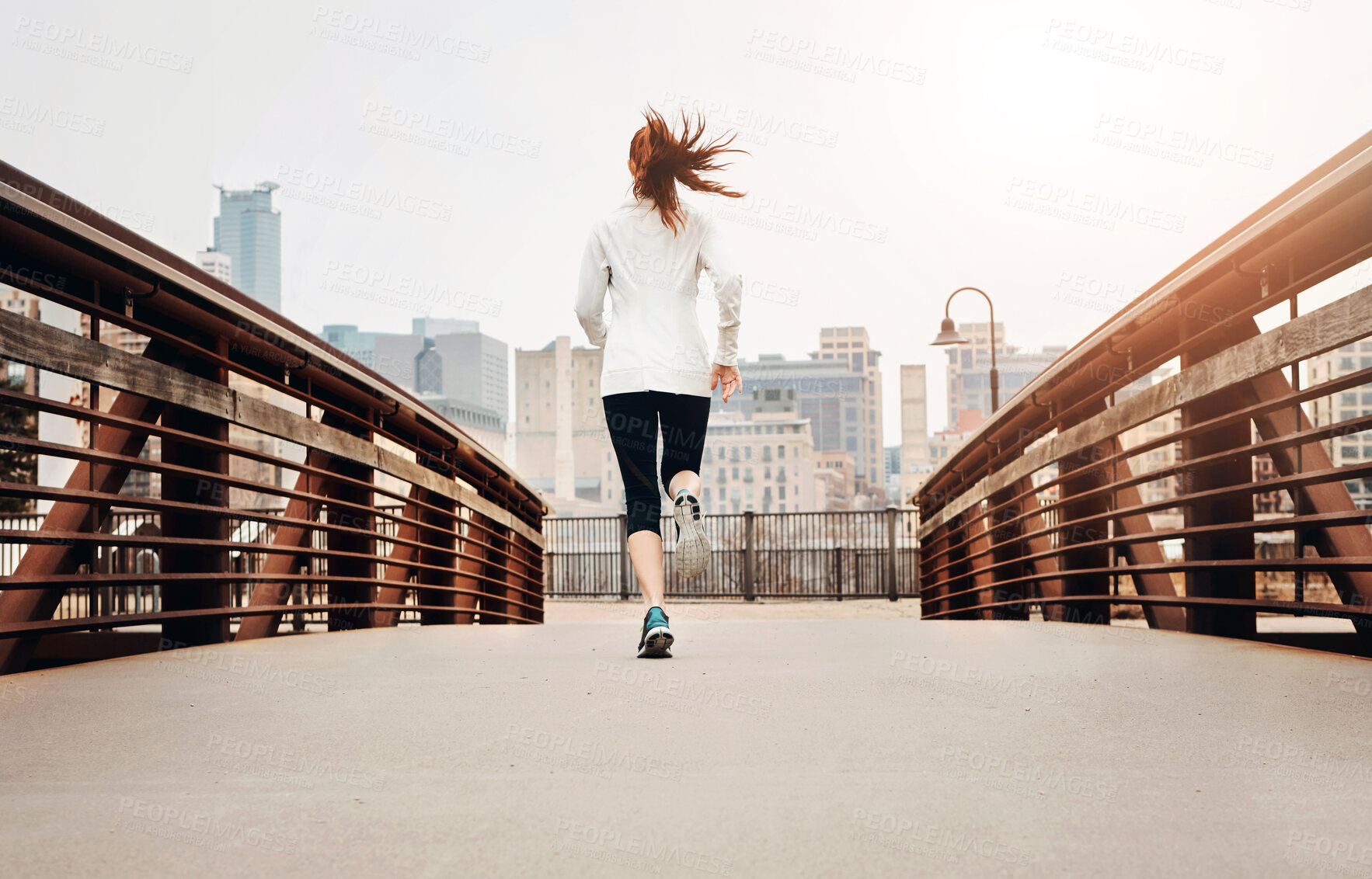 Buy stock photo Back, woman and running by bridge in city, endurance and speed with fitness exercise Germany. Training, female runner and preparation for marathon, challenge and healthy living with workout outdoor