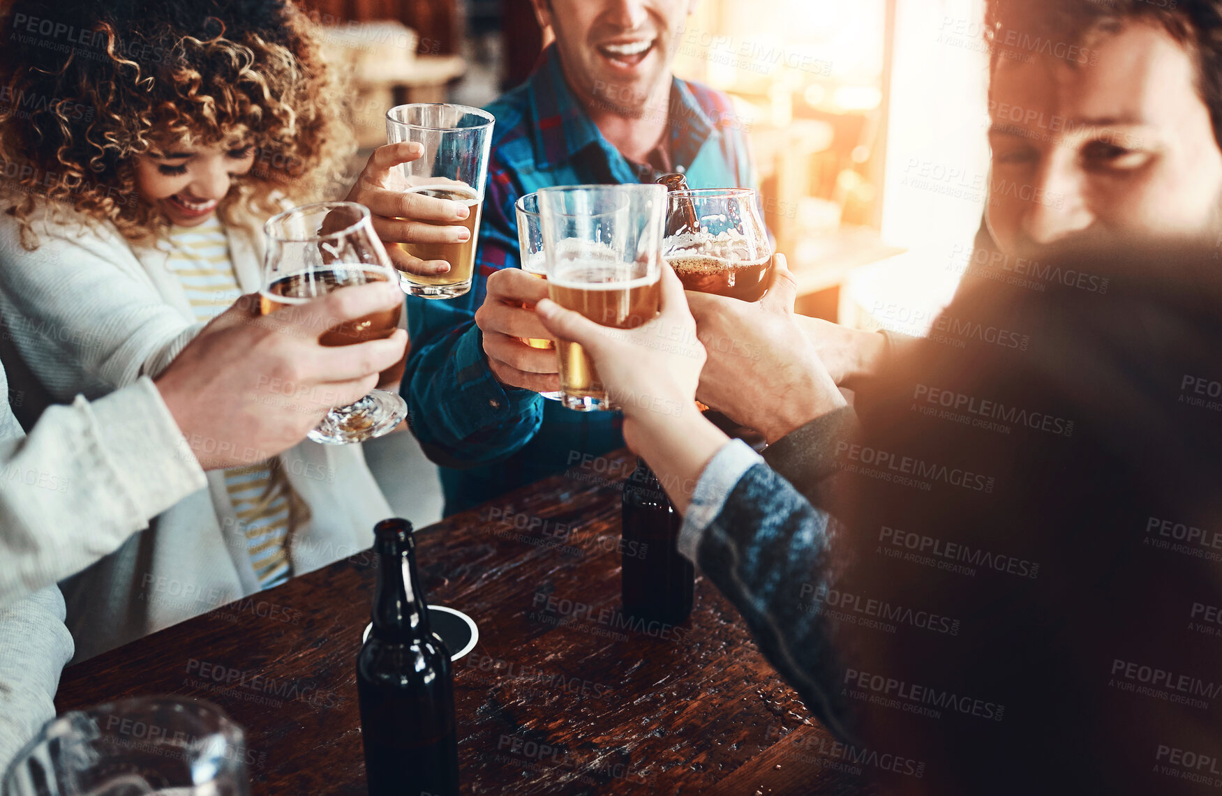Buy stock photo Friends, cheers and restaurant with celebration and reunion with beer at a pub or bar with happy people. Group, glasses and smile with drinks toast for social event or birthday together with fun