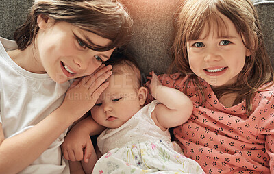 Buy stock photo Happy, portrait and siblings with baby on sofa bonding, embracing and relaxing together at home. Smile, love and young children hugging infant with care in couch in living room at family house.