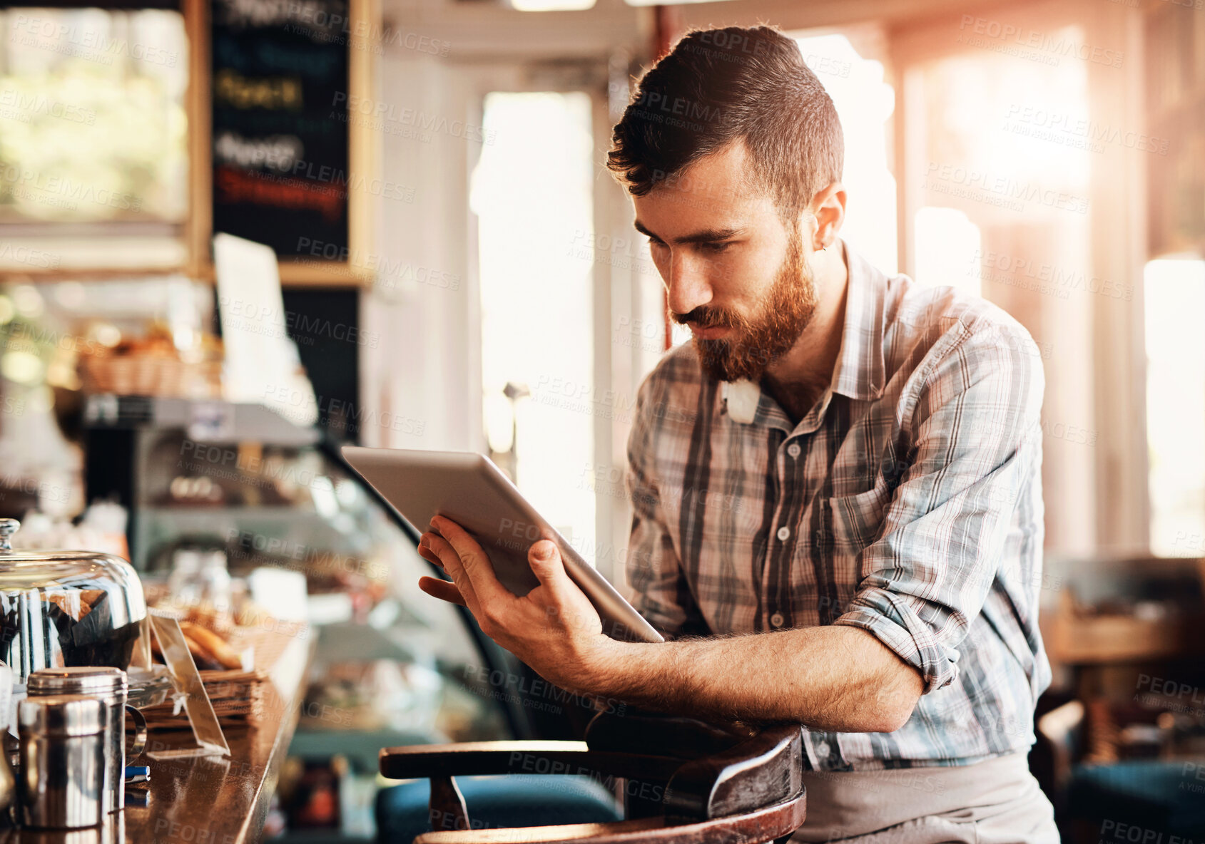 Buy stock photo Small business, barista and man with tablet in cafe for online reviews, coffee sales or update work schedule. Manager, restaurant and waiter with technology for stock inventory, checklist or menu