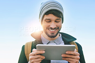 Buy stock photo Man, student and smile at tablet for social media, update and meme on internet. Comedy, happy and male person outside with technology for contact, communication and networking from low angle