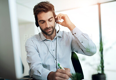 Buy stock photo Call center, customer service and man writing notes in office for online consultation appointment. Contact us, crm and male technical support or telemarketing agent with schedule for feedback.