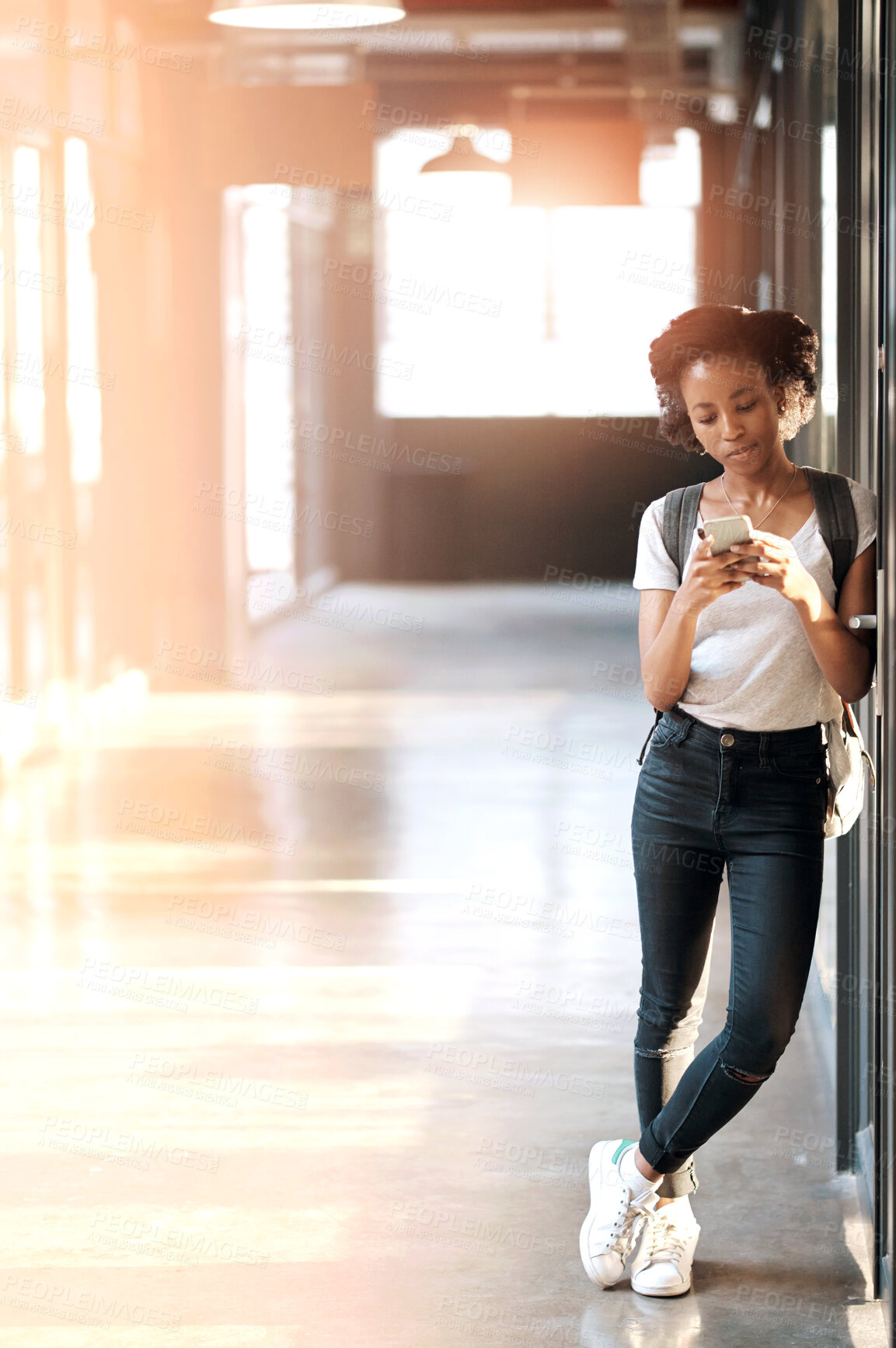 Buy stock photo Black girl, contact and reading message on phone in hallway for text classroom or online chat. Student, browsing schedule at university with smartphone, school social media with network or web search