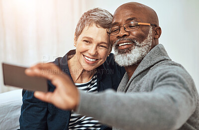 Buy stock photo Senior, couple and smile for selfie in house, living room and interracial people for social media together. Memory, relationship and capture on app, blog and internet post with love in photography