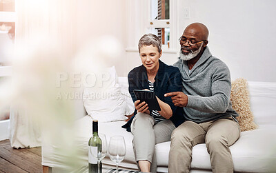 Buy stock photo Tablet, search and senior couple on sofa with love, support and sign up service choice while bonding at home together. Digital, date or elderly people in living room with app, wine and movie decision