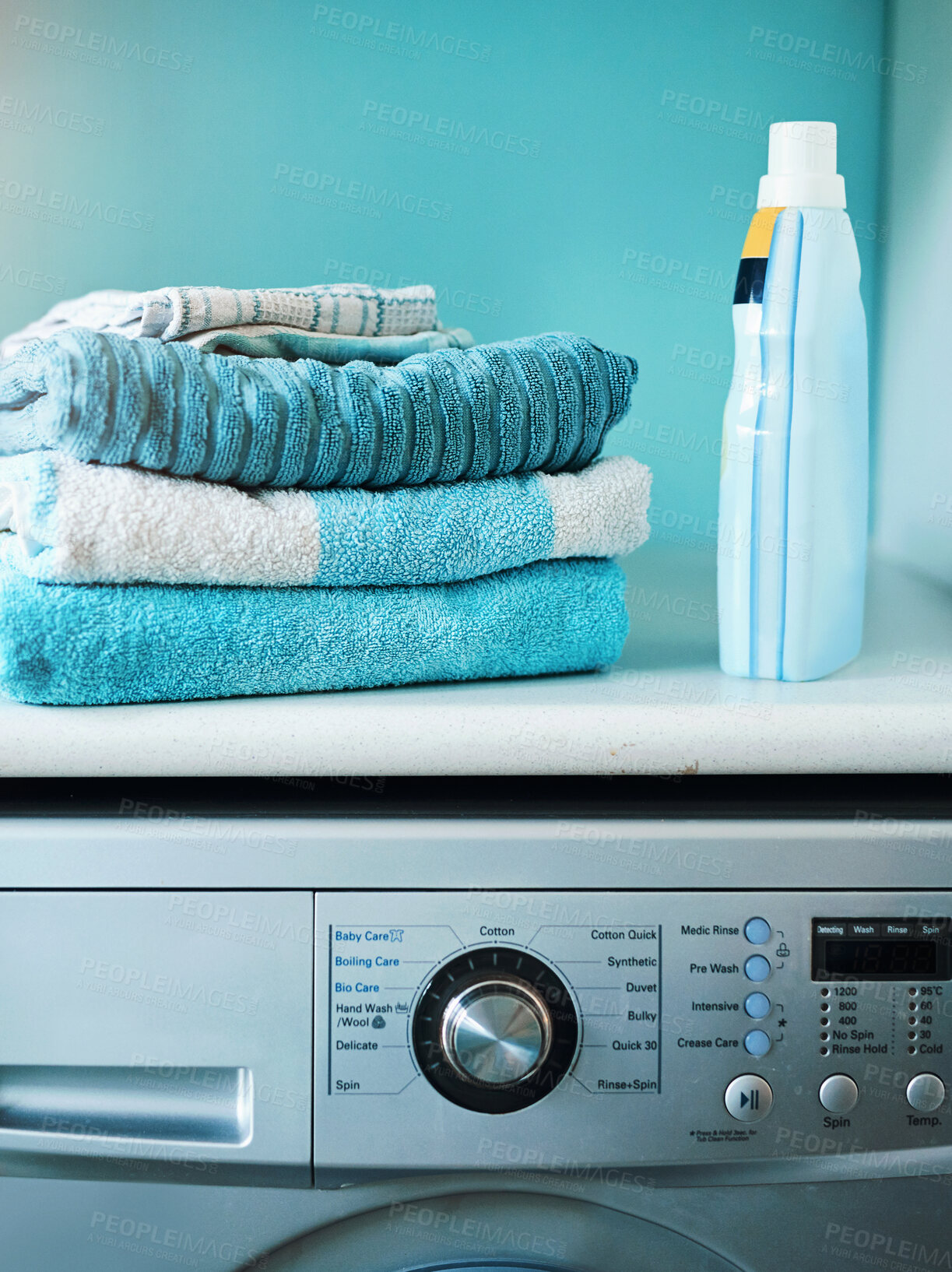 Buy stock photo Home, towel and washing machine with fabric bottle, cleaning and hygiene for house maintenance. Housekeeping, front loader and cotton and apartment appliance, detergent and laundry or liquid softener