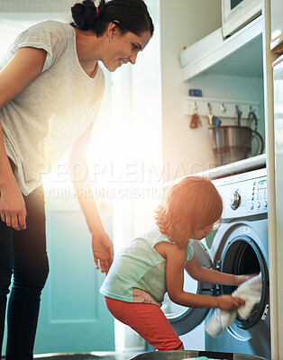 Buy stock photo Washing machine, laundry or mother and child in house for clothes, cleaning or weekend routine while bonding together. Housekeeping, help or mom and girl at home for learning, responsibility or teach