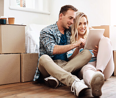 Buy stock photo New home, box and couple on floor with tablet for property, mortgage purchase and house investment. Homeowner, real estate and man and woman on digital tech for interior design, planning and website