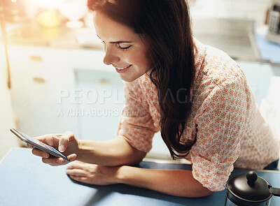 Buy stock photo Phone, smile and woman in kitchen at house networking on social media, internet or mobile app. Happy, cellphone and female person reading online email or text in morning for connectivity at home.