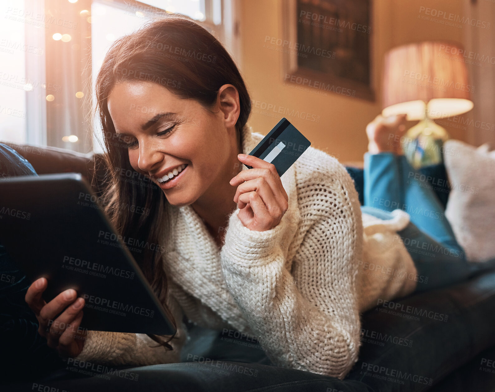 Buy stock photo Woman, happy and tablet with credit card on sofa for online shopping, payment and saving plan. Female person, home and  living room on couch with smile for internet banking, investment and discount