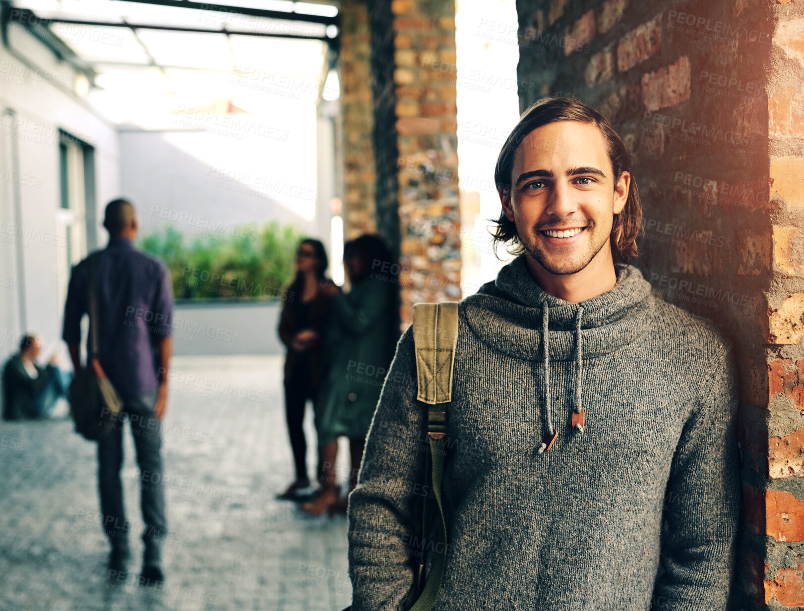 Buy stock photo Man, student and portrait with smile, college and backpack for education, learning or development by wall. Person, happy and bag sidewalk for studying, scholarship and outdoor at university in Berlin