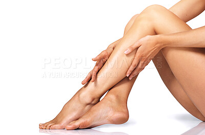 Buy stock photo Legs, person and smooth skin in studio on floor with grooming, results or cosmetics by white background. Model, hands and shine with health, transformation and change with hair removal for self care