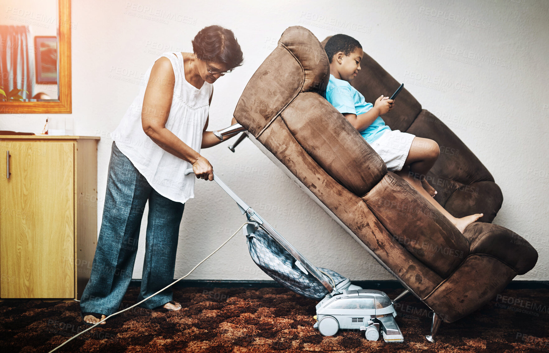 Buy stock photo Sofa, lift and cleaning woman with vacuum, strong and comedy with superwoman and housework job. Child, maid and working in a home with cleaner, comic and impossible task in a lounge with kid