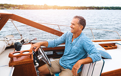 Buy stock photo Luxury, mature man and boat on water for retirement, leisure and investment for travel. Wealth, happiness and male person on yacht for sailing, adventure and transportation on lake in summer