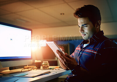 Buy stock photo Night, tablet and web development with man at desk in office for project deadline or research. Dark, scroll and technology with design employee in creative workplace for online administration