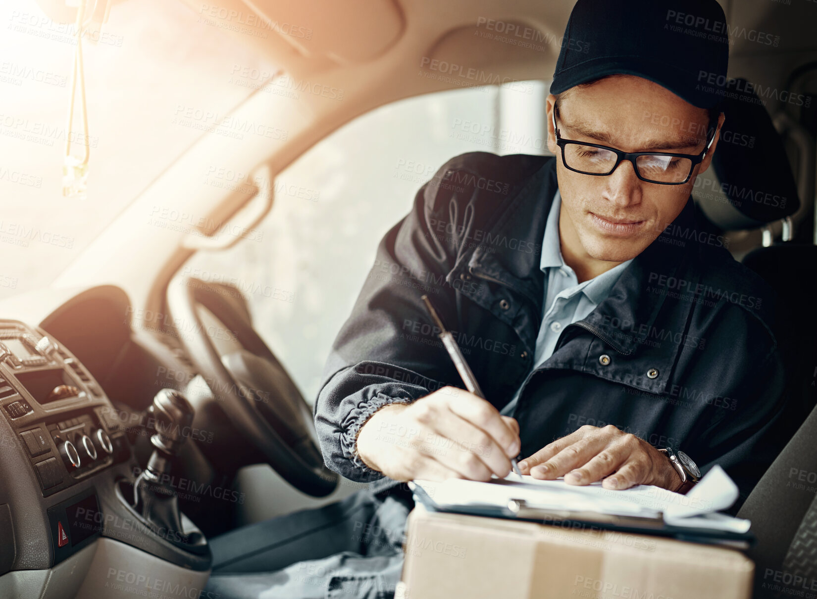 Buy stock photo Delivery man, writing and box in car with paperwork, stock or inventory for product, supply chain or shipping. Person, driver and courier for invoice with notes, cargo or transport for service in van