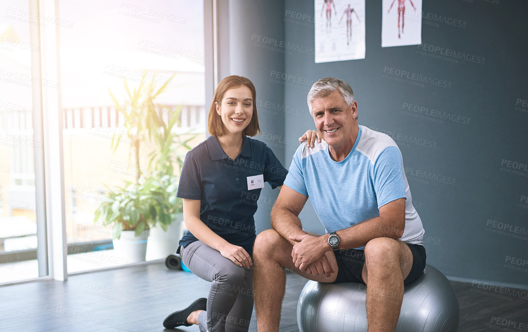 Buy stock photo Mature man, training and therapist in rehabilitation centre, physiotherapy, ball balance and exercise therapy. Portrait, woman and patient for physical wellness, anatomy recovery or mobile progress