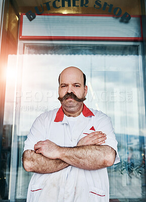 Buy stock photo Portrait, man and butcher at shop with arms crossed at small business startup. Worker, confidence and meat seller at store with serious face for retail inflation with professional outdoor in France