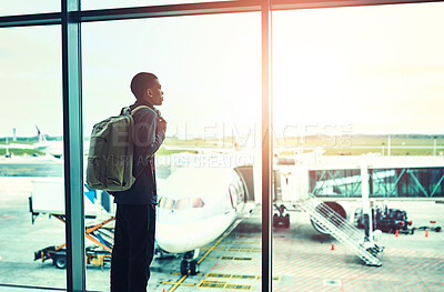 Buy stock photo Man, airport and backpack by window with plane, waiting for world adventure or global journey. Male person, vacation and luggage in terminal lounge for air travel, international holiday with flight