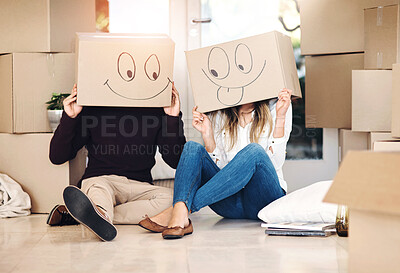 Buy stock photo New home, box and couple with emoji on floor for property, moving day and mortgage. Homeowner, real estate and man and woman with funny face drawing for relocation, packing and rental apartment