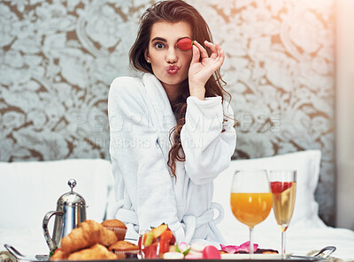 Buy stock photo Woman, portrait and strawberry in hotel for breakfast in bed with room service, food and hospitality. Female person, pout and healthy diet with nutrition for vacation, comfort and hungry in morning